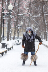An elderly gray-haired man with a magnificent mustache and beard looks into the distance and...