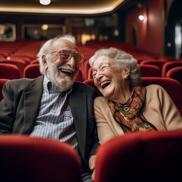 Laughing Elderly Couple, A Man And A Woman Watching Movie In The Cinema, A Comedy Show Or A Movie, Sitting In Comfortable Red Armchairs, A Mature Family, A Man And A Woman Enjoying Free Time Together