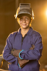 Woman welder in metalworking workshop 