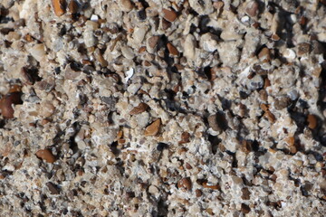 An ancient piece of cement from the bottom of the ocean that glued together many small pebbles of pebbles