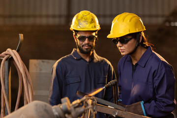 Two welder workers working at factory 