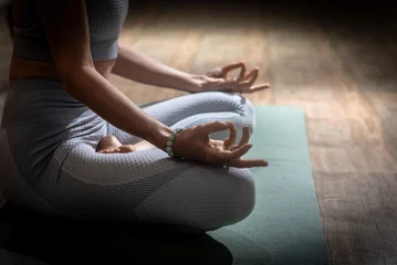 Wandcirkels plexiglas Beautiful woman practices kundalini yoga indoors. Wise © LN