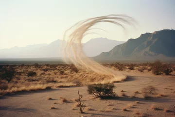 Fotobehang Spiraling dust devil in a desert landscape, illustrating the dynamic and ephemeral nature of these small-scale atmospheric phenomena. © Oleksandr