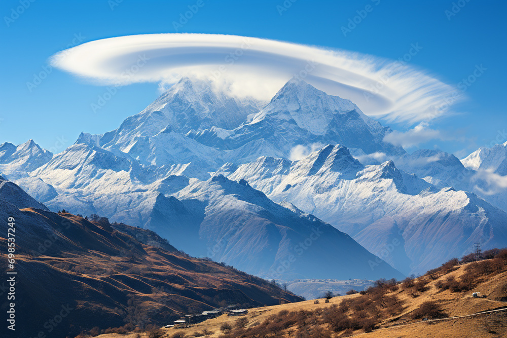 Poster lenticular cloud formation over mountain peaks, creating a striking and surreal atmospheric display.