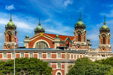 Photograph of the Ellis Island Immigration Museum under a beautiful blue sky, typical of the Big...