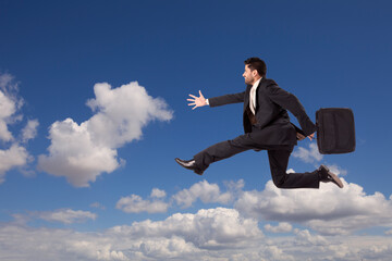 A businessman fearlessly ljumps into the sky