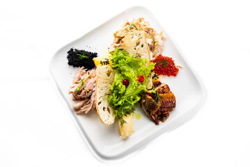 Mixed sliced fish and caviar on plate  isolated on white background.