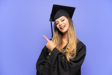 Young university graduate Russian girl isolated on white background pointing to the side to present a product