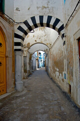 Among the historic alleys of the old Medina neighborhood of the city of Tunis, Tunisia - 698549618