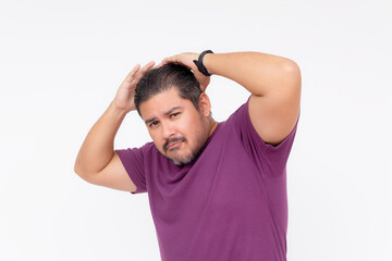 A egotistical man fixes his waxed hair trying to look cool, but looking funny instead. Wearing a purple waffle shirt. Half body photo isolated on white background.