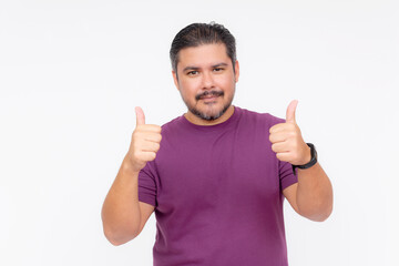 Portrait of a chubby bearded guy making the thumbs up sign with both hands. Wearing a purple waffle...