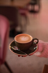 A cup of aromatic cappuccino into bowls
