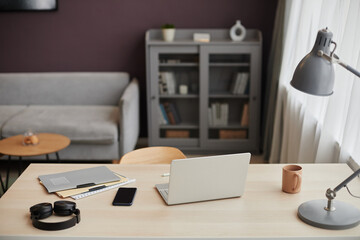Background image of home office workplace with open laptop on desk in minimal clean interior, copy space
