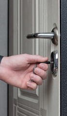 Inserting a key into the lock of a new house