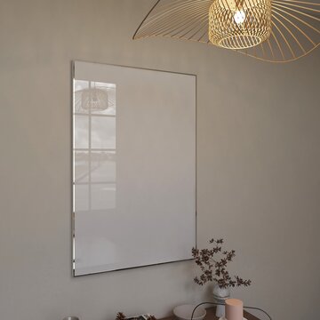 silver frame mockup on wall with wood lamp, modern neutral interior. Blank poster with light reflection side view, 3d render