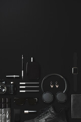 Black fashion and technology items flat lay on black background