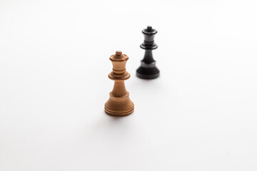 black and white chess pieces on white background, racism concept