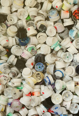 A large number of caps from cans of aerosol paint for graffiti. Smeared with colored paint nozzles...