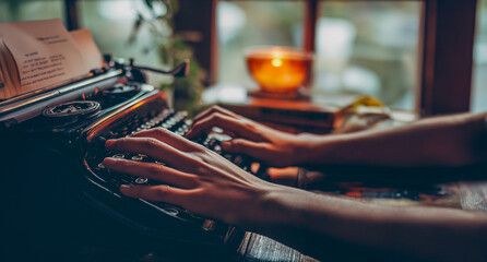 An old typewriter was placed on the left and someone was pressing the keys. beautiful background pictures