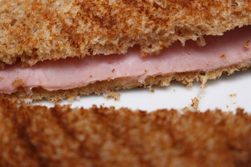 close up of a slice of bread. toasted ham sandwich. sandwich with selective focus.