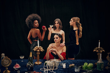 Beautiful young elegant women in stylish dresses attending dinner, celebrating birthday, New Year,...