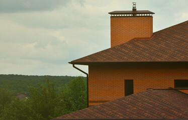 The house is equipped with high-quality roofing of shingles (bitumen tiles). A good example of perfect roofing. The roof is reliably protected from adverse weather conditions