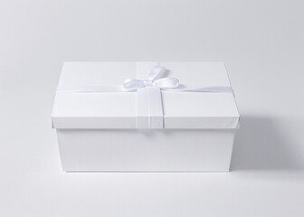Two white boxes with bows. 