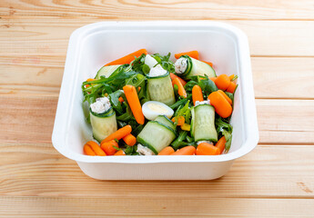 Cucumber rolls with sun-dried tomatoes. Healthy food. Takeaway food.  On a wooden background.