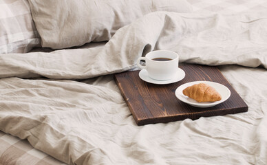 Fototapeta na wymiar coffee on tray on the bed in bedroom