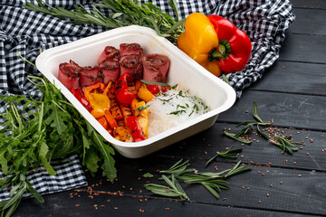 Funchoza with veal in “Sweet Chili” sauce. Healthy food. Takeaway food. On a wooden background.