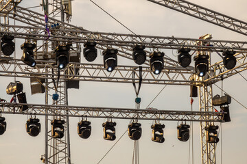 Outdoor concert stage with lighting equipment before performance. Stage construction. Installation...