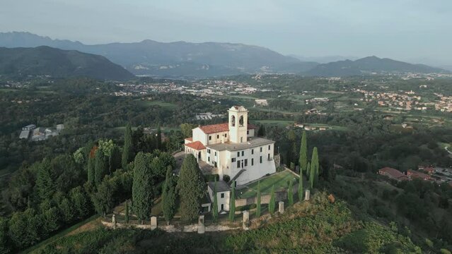 Aerial orbit around cathedral in Montevecchia, Italy named "Santuario della Beata Vergine del Carmelo". Stunning architecture and beautiful forests around. 4K drone shot.
