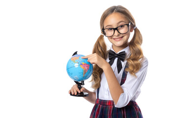 Sschoolgirl points her finger on a globe to the American continent. Girl 9 - 10 years old. Learn...