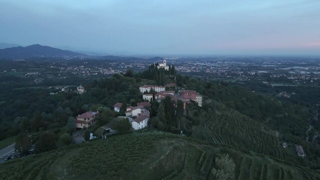 Aerial shot of the little village of Montevecchia, Italy. Stunning architecture and beautiful forests around. Countryside in the background. 4K drone shot.