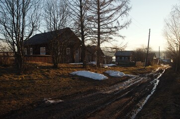 village house on a spring evening road snow streams