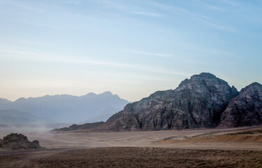 desert with rocky mountains and sky with clouds in the evening in Egypt