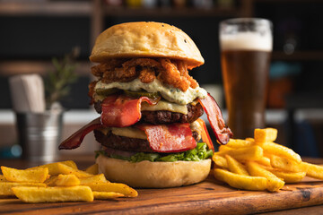 Spectacular double burger with cheese, bacon, fried onion rings, aioli sauce, bacon and lettuce,...