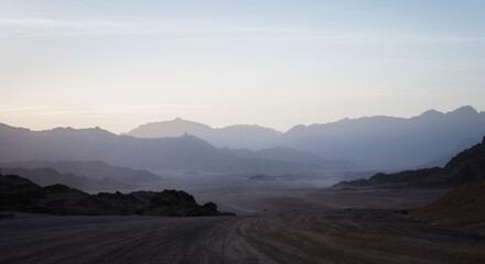 night desert landscape with rocky mountains and sunset sky with clouds in Sharm El Sheikh