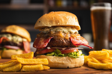delicious burger with cheese, bacon, caramelized onion rings, aioli sauce, bacon and lettuce,...