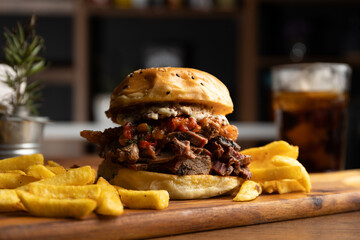 Brisket sandwich with sweet pepper, caramelized onion and aioli sauce served with a portion of...