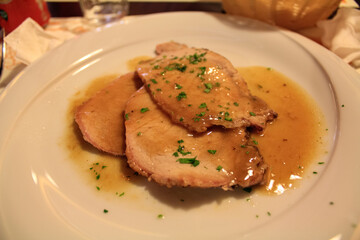 Close-up of the cooked pork. Dinner plate. Italian cuisine. Food concept.