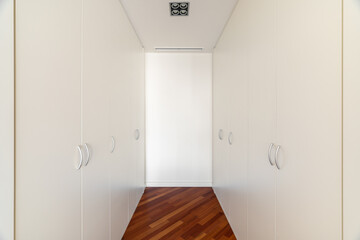 Dressing room area with built-in closets on both sides