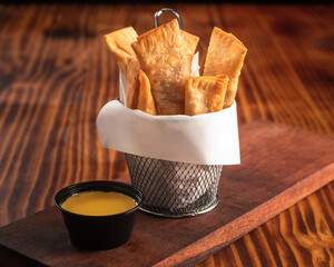 Fried tequenos stuffed with cheese and dipping sauce