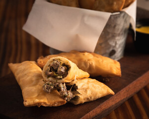 Snacks of tequenos stuffed with meat and dipping sauce