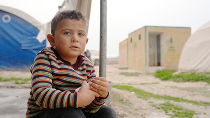 Syrian refugee children suffer from tragic humanitarian conditions in the winter. - obrazy, fototapety, plakaty