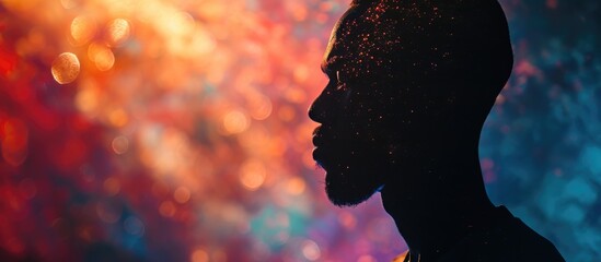 African American man's sad silhouette on neon background with space