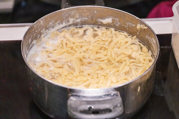 Preparation of Spätzle - Spaetzle, a Swabian type of noodle, preparation of food.