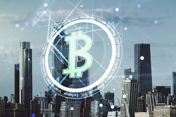 Virtual Bitcoin hologram on New York city skyline background. Multiexposure