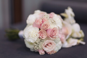 Wedding bouquet of the bride. Beautiful wedding bouquet with different flowers. Bride's and groom's a wedding bouquet. A beautiful photo with details of the wedding.