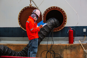 Male worker inspection the tank carbon chemical oil interface area confined space